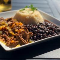 Ropa Vieja · Braised beef, bell peppers, onions, beans, rice, and parsley.