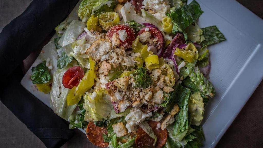 Italian Chopped Salad · grilled chicken, romaine, salami, red onion, tomato, artichoke hearts and smoked cheddar cheese with a creamy garlic parmesan dressing.