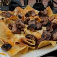 Nachos · traditional style nachos. Add chicken, beef, shrimp or bacon for an extra charge