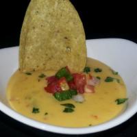 Chile Con Queso · Mexican cheeses, sweet tomatoes, onion, chiles. Add chicken, beef or shrimp for an extra cha...