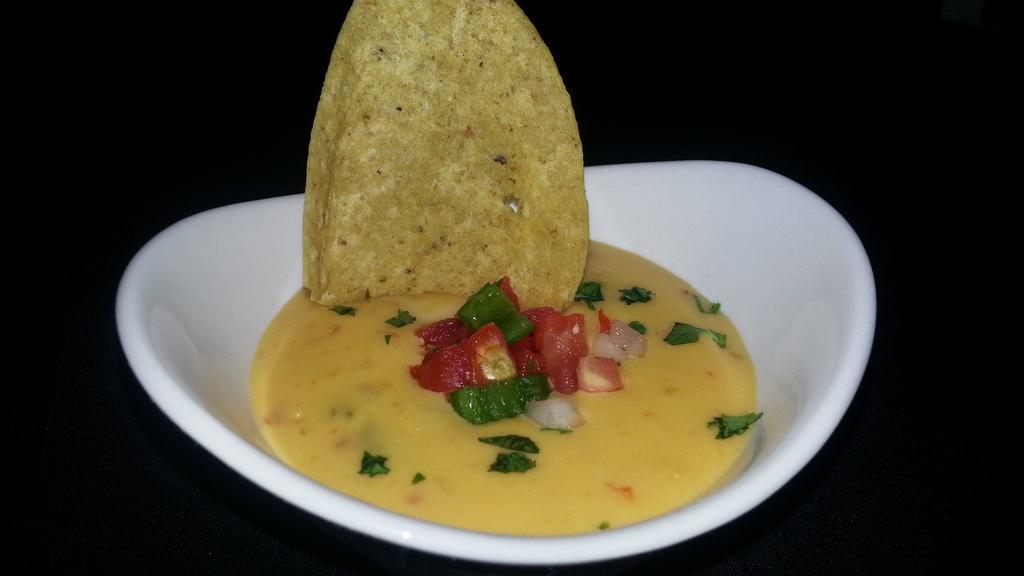 Chile Con Queso · Mexican cheeses, sweet tomatoes, onion, chiles. Add chicken, beef or shrimp for an extra charge