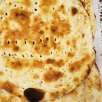 Tandoori Naan · Perfectly knead fluffy dough carefully flattened and cooked in a fiery clay oven.