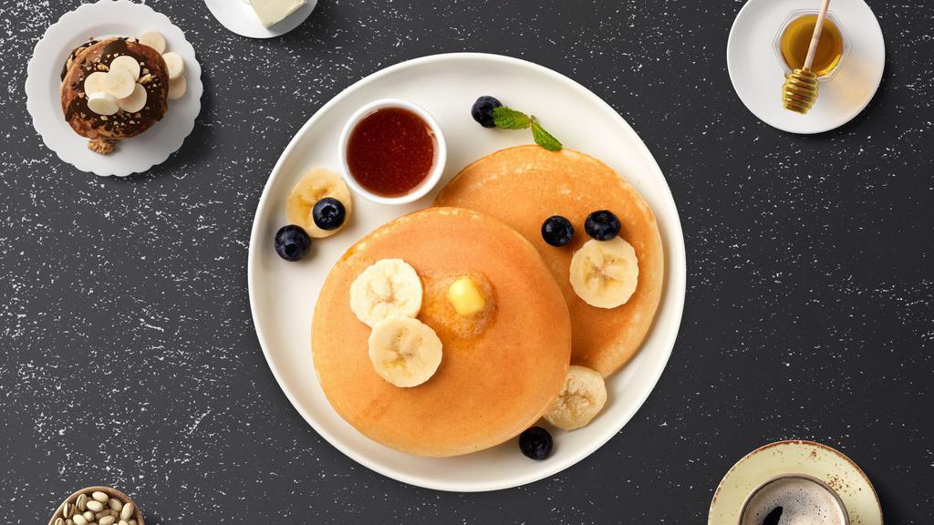 Banana Berry Pancakes · Fluffy banana and berries pancakes cooked with care and love served with butter and maple syrup. Served in threes.