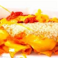 Elotes Fuego · Corn on the cob prepared with house chipotle mayo, nacho cheese, Hot Cheetos & Doritos Nacho...