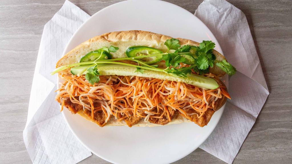Spicy Tofu Banh Mi · Deep fried tofu braised in spicy sate pepper with hummus spread on a sandwich.
