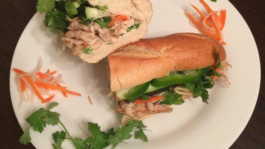 Jerk Chicken Banh Mi · Served with pineapple slices and a peppery cabbage pickling.