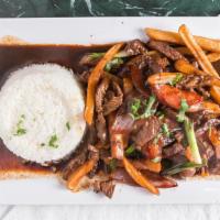 Lomo Saltado Carne O Pollo · Sliced beef or chicken stir-fried with red onions, tomatoes, soy sauce, vinegar and cilantro...