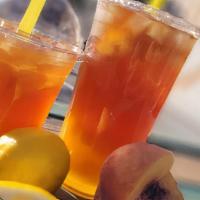 Mango Peach Iced Tea  · Camellia sinensis, black tea handcrafted with pure cane sugar, fresh lemons, mangos and peac...