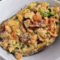 Fully Loaded Cajun Baked Potato · Russet potato overstuffed with sausage, shrimp, crawfish tails, chicken, and broccoli, toppe...
