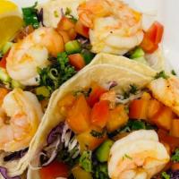 Shrimp Tacos · order of 2. Sautéed in lemon butter and house seasoning cabbage, cucumber, tomato, with cila...