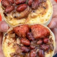Breakfast Burrito · Griddled flour tortilla, scrambled eggs on a bed of beans, choice of meat, potatoes, cheese,...