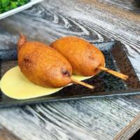 Thai Corn Dogs · house-made Thai sausage: ground pork, lemongrass and red curry, battered to order, served wi...