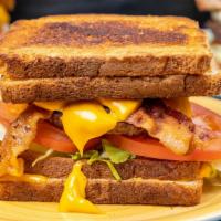 Triple Bypass · Two Grilled Cheese Sandwiches, Burger, Lettuce, Tomato, Bacon, and Cheese Sauce.