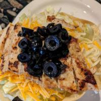Chicken Taco Salad · Crisp greens in a housemade flour tortilla shell topped with marinated, grilled chicken, Mon...