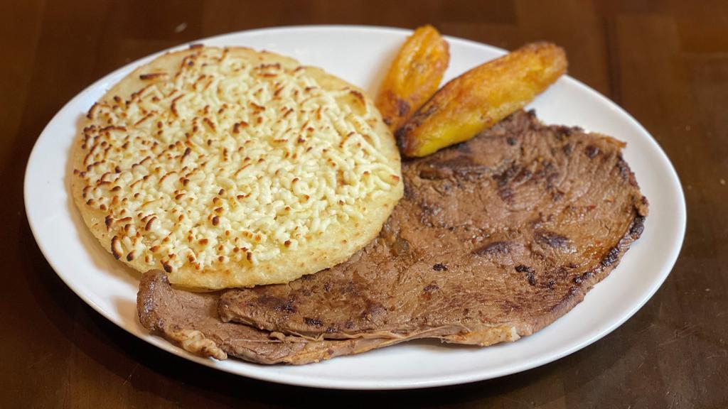 Carne Asada Con Arepa Con Queso · Grilled steak with corn cake with cheese.