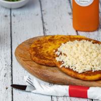 Arepa De Choclo Con Queso · Sweet corn cake with cheese.