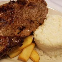 Churrasco · New York steak. Grilled steak served with rice, French fries, and salad.