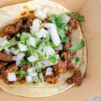 Asada Taco · Grilled beef on corn tortillas + white onions and cilantro, just pick your salsa spice level.