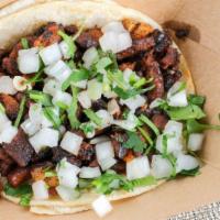 Al Pastor Taco · Marinated pork on corn tortillas + white onions and cilantro, just pick your salsa spice lev...