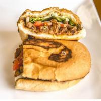 Asada Torta · Grilled beef. Mexican sandwich that includes refried beans, onions, guacamole, lettuce, toma...
