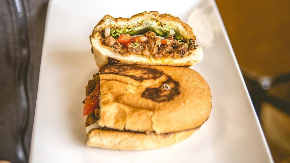 Chorizo Torta · Pork sausage. Mexican sandwich that includes refried beans, onions, guacamole, lettuce, tomatoes, and mayonnaise.