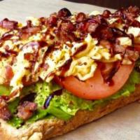 Loaded Avocado Toast · smashed avocado, tomato, bacon bits, red pepper flakes, and light balsamic glaze on toasty w...