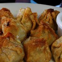 Dumplings (Steamed Or Fried) (6) · Minced pork with yellow onion, water chestnut, and garlic, wrapped in wonton skin, served wi...