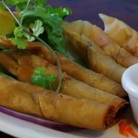 Fried Shrimp Rolls (6) · Shrimp and yellow onions, wrapped in crispy egg roll shell, served with house sweet & sour s...