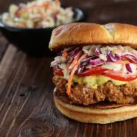 The Curry Clucker · curry fried chicken* marinated in a house curry sauce, topped with slaw & tomatoes