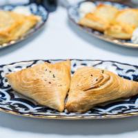 Samsa · Thinly rolled butter dough stuffed with seasoned dices of lamb, onions and spices, baked to ...
