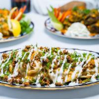 Manti · Steamed uzbek dumplings stuffed with diced seasoned lamb, onions and spices. Served with yog...