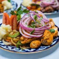 Chicken Shashlyk (Shish Kabob) · Marinated pieces of chicken thighs, grilled until tender, topped with red onions and served ...