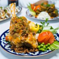 Lamb Shank · Marinated lamb shank steamed cooked, topped with tomato based sauce, served with steamed veg...