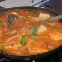 부대 찌개 / Budae Jjigae · Stew made with ham, hot dogs, pork, kimchi, and tofu in vegetable stock.