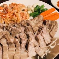 보쌈 / Bossam · Boiled pork belly with vegetables and special kimchi.
