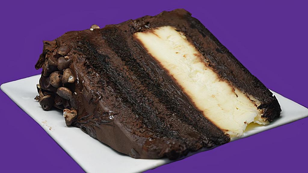 Chocolate Cheesecake Explosion · A layer of cheesecake between layers of moist devils food chocolate cake alternated with layers of chocolate fudge icing.  This extravagant cake is then finished with chocolate shavings on the sides.