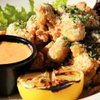 Artichoke Hearts · Crispy marinated artichoke hearts tossed in a Parmesan and Romano cheese blend. Served with ...
