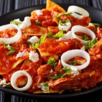 Chilaquiles Colorados Plate · Chilaquiles made with corn tortilla chips mixed in with red sauce, queso fresco, and sour cr...
