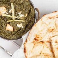 Saag Paneer · Fresh homemade cheese cooked in a flavorful spinach and mild spices.