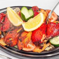 Tandoori Chicken · Chicken on the bone marinated overnight in yogurt and spices and then barbecued in the tando...