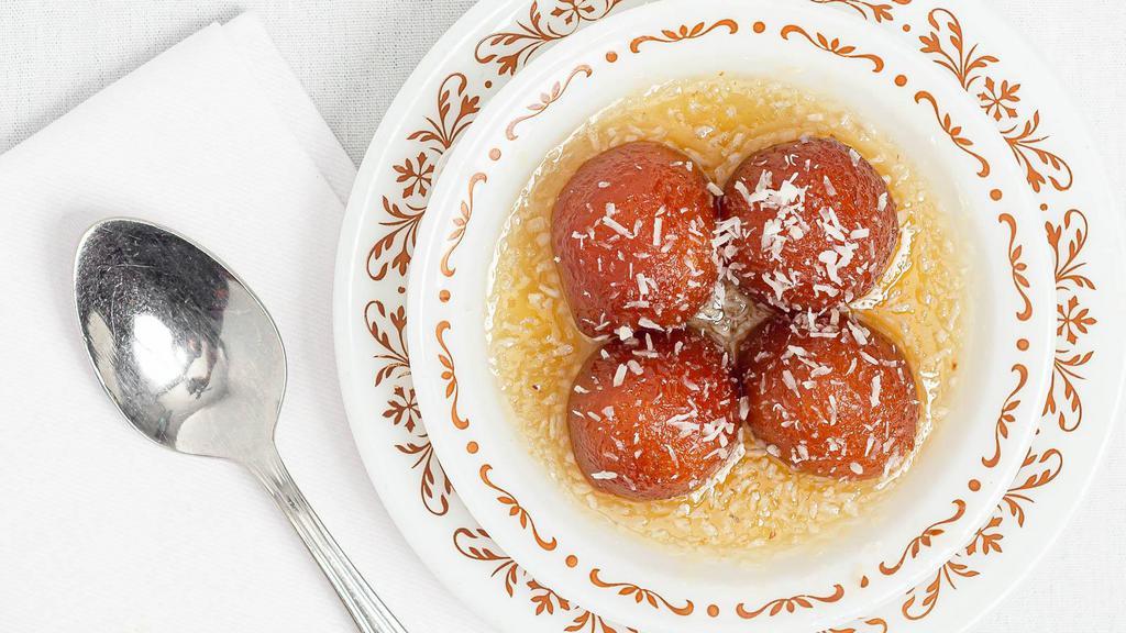 Gulab Jamun · Homemade deep fried cottage cheese balls dipped in a honey and rosewater syrup and topped with almonds.