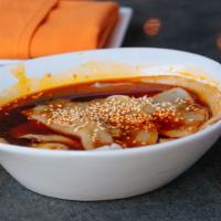 Pork Dumplings In Chili Oil · Eight (8) pork dumplings served in hot garlic chili oil, sweetened soy sauce and topped with...