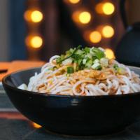 Sichuan Cold Noodles With Chili Oil · flour lo-mein style noodles tossed with chili oil, soy sauce, and crushed peanuts, topped wi...