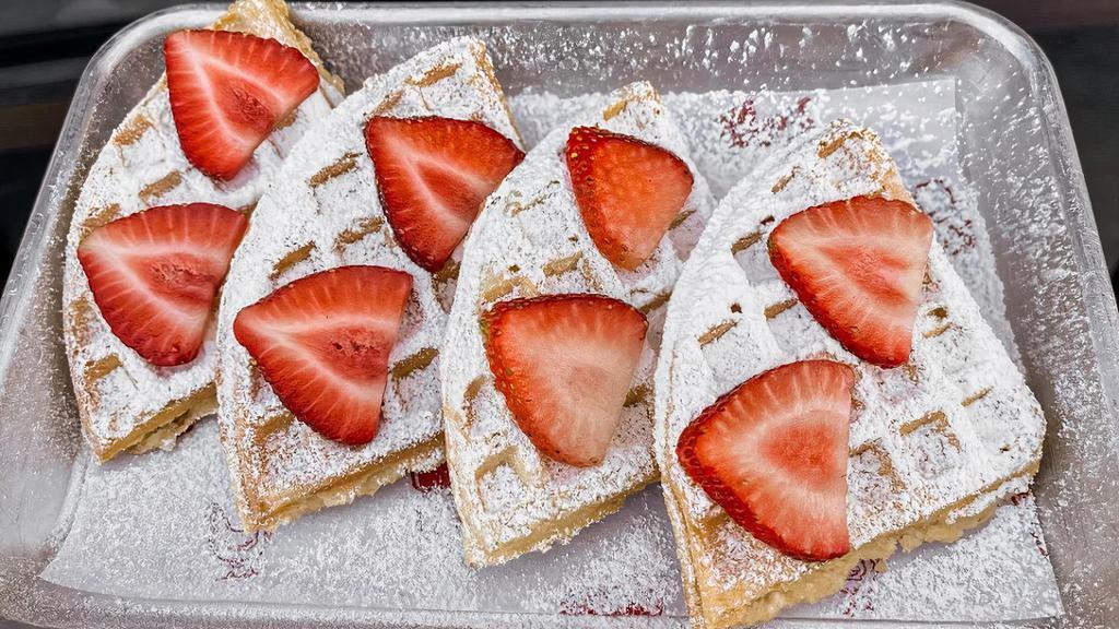 Waffle · topped strawberries and powdered sugar with syrup on the side