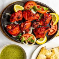 Tandoori Chicken · Comes with naan or rice and salad.