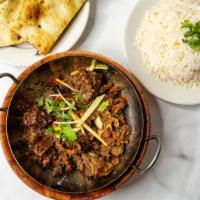 Achari Beef Karahi · Slow cooked meat in curry, infused with spices, tomatoes onions, yogurt.