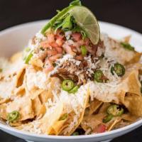 Great American Nachos · Cheese sauce, serranos, pico, green onions, cilantro, cotija and lime. Add meat and add avoc...