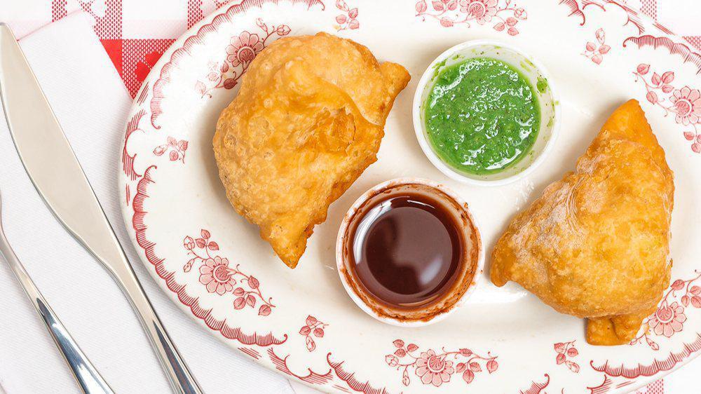 Vegetable Samosa · Crispy fried turnover, filled with delicious mildly spiced vegetables.
