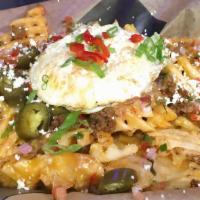 Trash Frys · Waffle fries, sunny side up egg, cheddar jack blend queso, pico, jalapeños, tequila cream an...