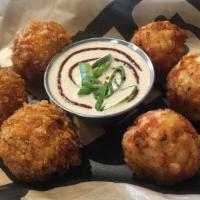 Potato Puffs · Golden fried bites of heaven! Potatoes, cheese and sour cream with chipotle ranch dipping sa...